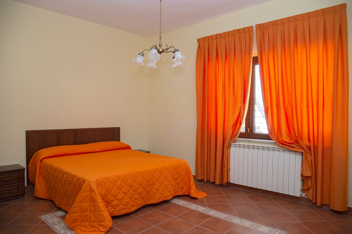 Bedroom with warm-toned curtains