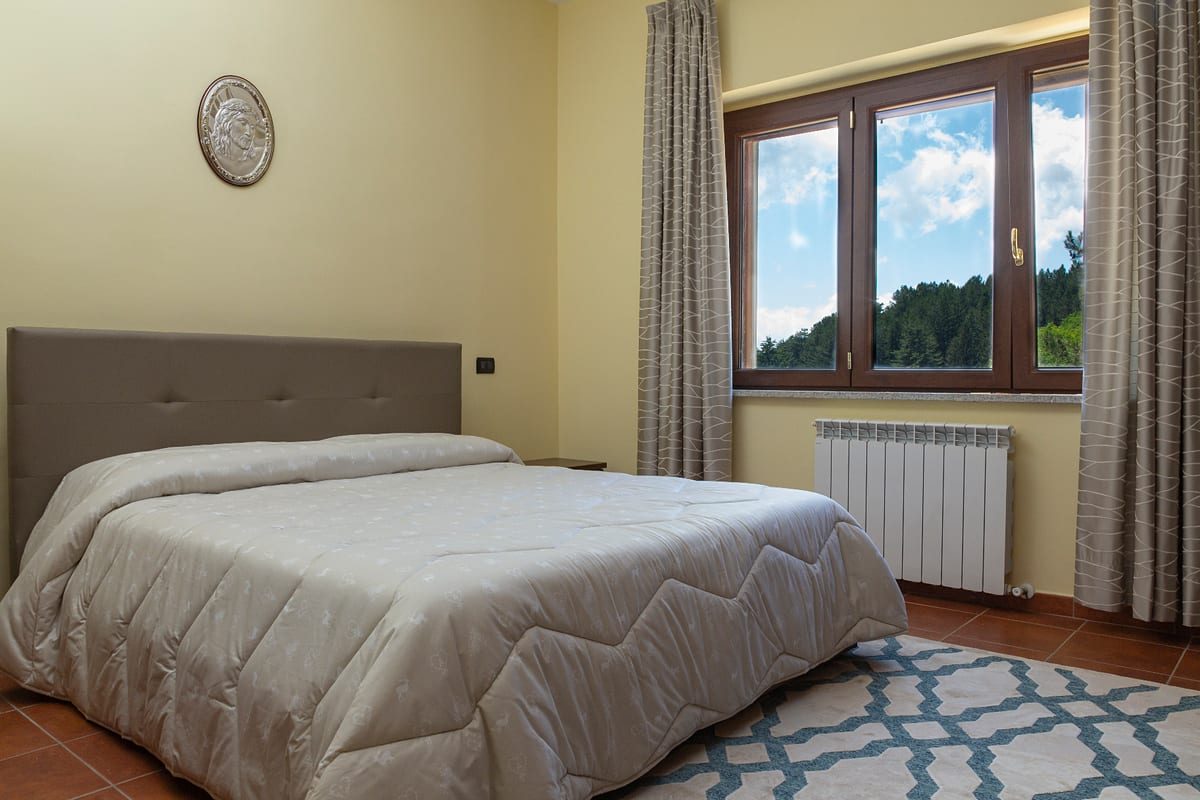 Bedroom with view of the woods