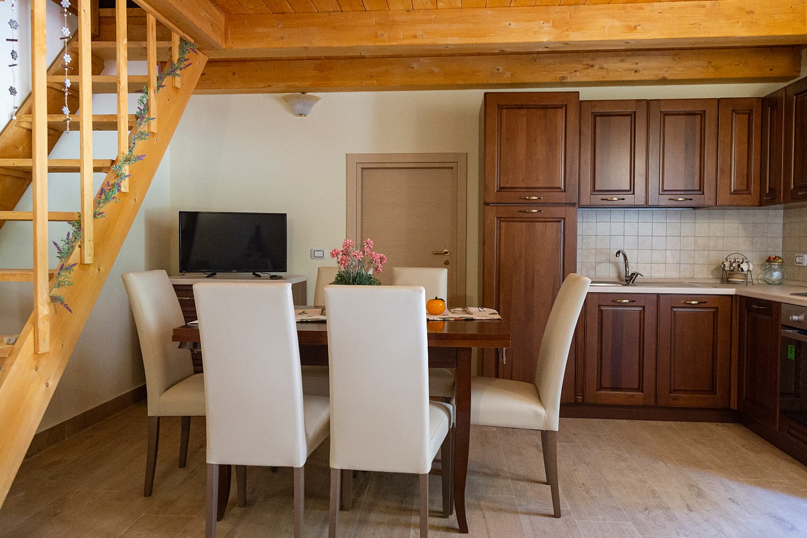 Dining room with wooden staircase